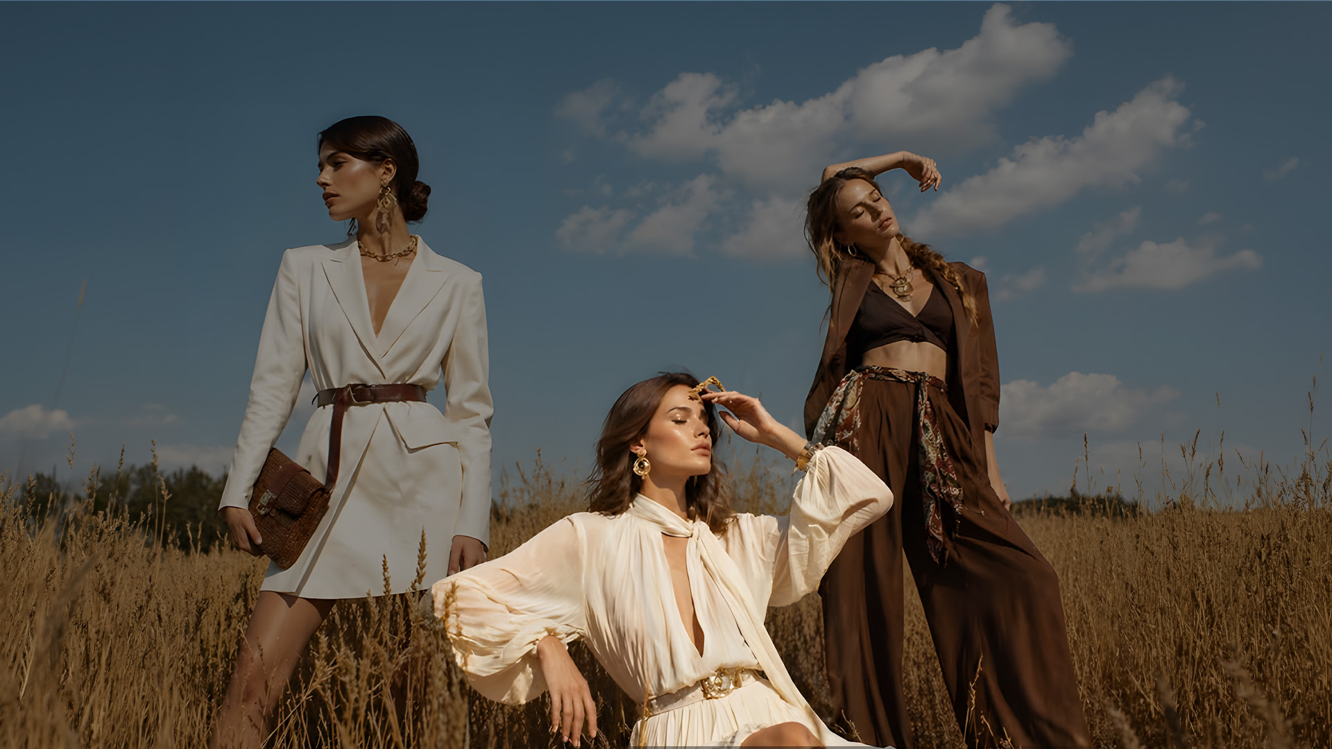 Vestura SS24 campaign — three models in a golden wheat field